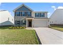 Beautiful two-story home featuring a two car garage and meticulously maintained lawn at 221 Begonia Way, Mcdonough, GA 30253