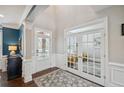 Elegant foyer with tall ceilings, hardwood floors, framed by white pillars, and a lovely entryway rug at 320 Harvest View Ter, Woodstock, GA 30188