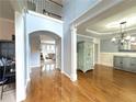 Spacious foyer with hardwood floors, an archway, and views into the dining room and office at 4769 Moon Hollow Ct, Buford, GA 30519