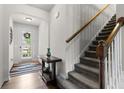 Bright entryway featuring hardwood floors, a staircase, and a view to the front door at 1539 Creek Bend Ln, Lawrenceville, GA 30043