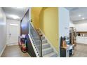 Inviting entryway with a staircase, colorful decor, and a glimpse into the modern kitchen at 156 Woodhouse Cir, Acworth, GA 30102