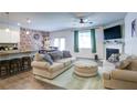 Cozy living room with comfortable sofas, a fireplace, and an open layout to the kitchen at 156 Woodhouse Cir, Acworth, GA 30102