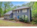 Charming two-story home with blue siding, white shutters, landscaped yard and bright blue front door at 295 N Fayette Dr, Fayetteville, GA 30214
