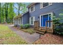 Inviting entrance showcasing well-maintained landscaping and bright blue front door at 295 N Fayette Dr, Fayetteville, GA 30214