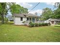 Lovely single-story home featuring a cozy covered front porch and lush green lawn at 6648 Florence Dr, Lithia Springs, GA 30122