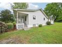 Exterior view of a well-maintained home with a green lawn, showcasing its tidy side and rear at 6648 Florence Dr, Lithia Springs, GA 30122