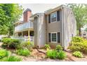 Exterior view of home featuring neutral siding, classic shutters, and a charming, landscaped yard at 1750 Clairmont Rd # 32, Decatur, GA 30033
