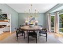 Well-lit dining room with modern chandelier and neutral color palette at 305 Jasmine Ct, Woodstock, GA 30189