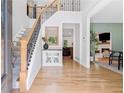 Inviting foyer with hardwood floors, staircase, and view to the living room at 305 Jasmine Ct, Woodstock, GA 30189