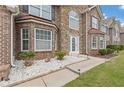 Welcoming front entrance with stone accents, a white front door, and meticulously landscaped surroundings at 6637 Chason Woods Ct, Jonesboro, GA 30238