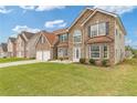 Attractive brick and stone two-story home with a lush lawn, attached two-car garage, and inviting curb appeal at 6637 Chason Woods Ct, Jonesboro, GA 30238
