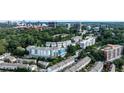 Aerial view of the community nestled among lush trees with city skyline in the background at 130 26Th St # 402, Atlanta, GA 30309