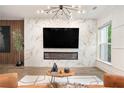 Stylish living room featuring a fireplace, marble accent wall, and hardwood floors at 2505 Astaire Nw Ct, Atlanta, GA 30318