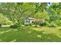 Scenic exterior showcasing the home amidst a lush, tree-filled landscape, providing a sense of privacy at 316 Shiloh Hills Nw Dr, Kennesaw, GA 30144