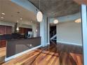 Kitchen and living room with hardwood floors and modern pendant lighting at 3324 Peachtree Ne Rd # 3001, Atlanta, GA 30326