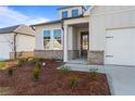 Inviting front entrance with beautiful landscaping and a welcoming front door at 1682 Juniper Berry Way, Loganville, GA 30052