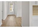 Bright hallway featuring wood floors leading to the main living areas at 1682 Juniper Berry Way, Loganville, GA 30052