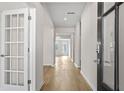 Inviting hallway with natural light and hardwood floors throughout the house at 1682 Juniper Berry Way, Loganville, GA 30052