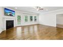 Bright living room with hardwood floors, fireplace, and large windows providing lots of natural light at 306 Lark Ln, Canton, GA 30115
