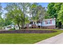 Charming split-level home with brick accents, mature trees, and a well-maintained lawn at 3116 Lakepoint Cir, Acworth, GA 30102