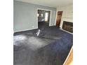 Spacious living room with blue carpet and fireplace at 6 Rockmart Sw Dr, Atlanta, GA 30314