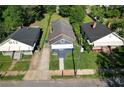 Aerial shot of a blue one-story home with well-maintained lawns, nestled between neighboring houses at 1286 Allene Sw Ave, Atlanta, GA 30310