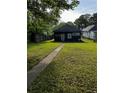 View of the backyard with a well-maintained lawn and a glimpse of the home's exterior at 1286 Allene Sw Ave, Atlanta, GA 30310