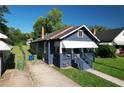 A charming blue one-story home with a covered porch and well-kept lawn in a suburban setting at 1286 Allene Sw Ave, Atlanta, GA 30310
