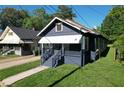 Quaint blue one-story home with covered porch, and a manicured lawn next to neighboring houses at 1286 Allene Sw Ave, Atlanta, GA 30310