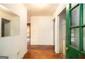 Inviting entryway with hardwood floors and fresh, green painted door frame at 1491 Boulderwoods Dr, Atlanta, GA 30316