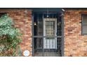 Inviting front door with security bars providing charm and security at 1491 Boulderwoods Dr, Atlanta, GA 30316