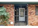 A close up of the front door and secure gate of this brick home at 1491 Boulderwoods Dr, Atlanta, GA 30316