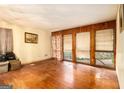 Spacious living room featuring hardwood floors and large windows allowing ample natural light at 1491 Boulderwoods Dr, Atlanta, GA 30316