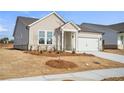 Charming single-story home highlighting a light exterior, manicured lawn, and an attached two-car garage at 1783 Juniper Berry Way, Loganville, GA 30052