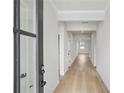 Bright hallway with gray walls, wood-look floors, and modern door hardware at 1783 Juniper Berry Way, Loganville, GA 30052