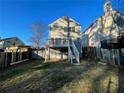 View of the back of the house, with a deck and a spacious, fenced backyard at 3210 Linden Dr, Lawrenceville, GA 30044