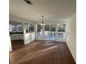 Bright dining area with hardwood floors, stylish lighting, and sliding glass doors leading to the deck at 3210 Linden Dr, Lawrenceville, GA 30044