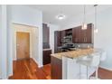 Kitchen featuring granite counters, dark cabinets, breakfast bar with seating at 870 Inman Village Ne Pkwy # 229, Atlanta, GA 30307