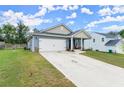 Inviting one-story home featuring an attached two-car garage, covered porch, and neat lawn at 99 Oxford Ln, Kingston, GA 30145