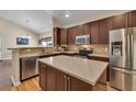 Modern kitchen featuring stainless steel appliances, sleek cabinetry, and a convenient center island at 2318 Chancery Mill Ln, Buford, GA 30519
