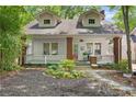 Charming two-story home with white siding, brick accents, front porch, dormer windows, and landscaped front yard at 291 Elmira Ne Pl, Atlanta, GA 30307