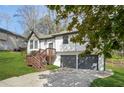 Beautiful home with two-car garage, wood deck, a well maintained lawn, and mature trees at 5570 Deerfield Nw Pl, Kennesaw, GA 30144