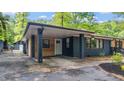 View of the carport showing the brick and wood accent siding and its convenient access to the main house at 715 Wood Valley Rd, Mableton, GA 30126