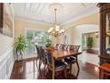 Elegant dining room with hardwood floors, coffered ceilings, and a chandelier at 2120 Cain Commons Dr, Dacula, GA 30019