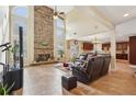Spacious living room with a stone fireplace, tall ceilings, and tile flooring at 2120 Cain Commons Dr, Dacula, GA 30019