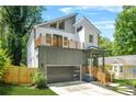 Modern two-story home showcasing a balcony, unique garage door, and professional landscaping at 2186 Park Terrace, College Park, GA 30337