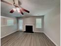 Inviting living room with a cozy fireplace, ceiling fan, and neutral tones at 2429 Wood Bend Ln, Riverdale, GA 30296
