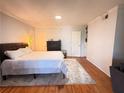 Bright bedroom featuring hardwood floors, a comfortable bed, and neutral decor at 1150 Collier Nw Rd # 25D, Atlanta, GA 30318