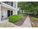 Charming condo building with well-manicured bushes and convenient walkway access at 1150 Collier Nw Rd # 25D, Atlanta, GA 30318