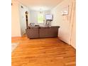 Spacious living room with hardwood floors, comfortable seating, and a view into the open-concept design at 1150 Collier Nw Rd # 25D, Atlanta, GA 30318